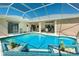 Gorgeous lanai featuring a refreshing private pool and an outdoor seating area with ample space for relaxation at 1311 Pine Siskin Dr, Punta Gorda, FL 33950
