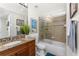 Bathroom featuring granite countertop, wood cabinets, and tiled shower with glass door at 1340 Rock Dove Ct # 132, Punta Gorda, FL 33950