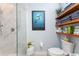 Well decorated bathroom with a glass-enclosed shower, elegant shelving, and modern fixtures with an ocean themed art piece at 1340 Rock Dove Ct # 132, Punta Gorda, FL 33950