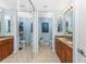 Dual sink bathroom with granite countertops, a separated toilet area, and mirrored closets at 1340 Rock Dove Ct # 132, Punta Gorda, FL 33950