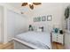 Bedroom with white furnishings, closet, and nautical themed wall decor at 1340 Rock Dove Ct # 132, Punta Gorda, FL 33950