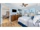 Bedroom with ceiling fan, sliding glass door, hardwood floors, and coastal decor at 1340 Rock Dove Ct # 132, Punta Gorda, FL 33950