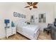 Cozy bedroom with wooden floors, ceiling fan and tropical themed decorations and furnishings at 1340 Rock Dove Ct # 132, Punta Gorda, FL 33950