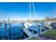 Well maintained boat lift with a sleek sailboat ready to be launched on a beautiful day under a clear blue sky at 1340 Rock Dove Ct # 132, Punta Gorda, FL 33950
