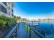 Community dock and canal featuring well maintained railings and docks with a gorgeous building nestled in the background at 1340 Rock Dove Ct # 132, Punta Gorda, FL 33950