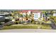 Beautiful low angle daytime exterior view of the condo with palm trees and well maintained landscaping at 1340 Rock Dove Ct # 132, Punta Gorda, FL 33950