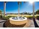 Water fountain is surrounded by landscaping, lush lawns, palm trees, and perfectly manicured gardens under a brilliant sky at 1340 Rock Dove Ct # 132, Punta Gorda, FL 33950