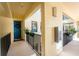 Bright hallway with a lovely blue door, dark railings, decorative plants, and a calming, welcoming atmosphere at 1340 Rock Dove Ct # 132, Punta Gorda, FL 33950