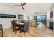 Open-concept living area with wood floors, a dining table, comfortable seating, and sliding glass doors to the balcony at 1340 Rock Dove Ct # 132, Punta Gorda, FL 33950