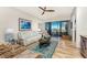 Bright living room with wood floors, comfortable furnishings, ceiling fan, and sliding doors to the balcony at 1340 Rock Dove Ct # 132, Punta Gorda, FL 33950