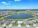 Aerial view of a community with a large lake surrounded by beautiful homes at 16064 Shoreline Dr, Punta Gorda, FL 33982