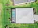 Aerial view of a private backyard, swimming pool and well-maintained roof and landscaping at 16064 Shoreline Dr, Punta Gorda, FL 33982