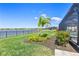 View of the backyard with lush landscaping and a glimpse of the screened-in pool at 16064 Shoreline Dr, Punta Gorda, FL 33982
