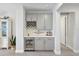 Elegant bar area with custom cabinetry, a wine rack, a beverage cooler, and stylish finishes, great for entertaining at 16064 Shoreline Dr, Punta Gorda, FL 33982