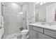 Bathroom featuring modern shower with glass door, vanity, neutral colors, and wood look tile at 16064 Shoreline Dr, Punta Gorda, FL 33982