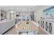 Bright dining area with an open view of the modern kitchen, a large table, and stylish decor, perfect for Gathering gatherings at 16064 Shoreline Dr, Punta Gorda, FL 33982