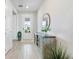 Welcoming foyer featuring tile flooring, a decorative table, and glass pane front door at 16064 Shoreline Dr, Punta Gorda, FL 33982