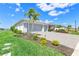 Well-maintained single-story home with a spacious three-car garage, complemented by lush green lawns and a paved driveway at 16064 Shoreline Dr, Punta Gorda, FL 33982