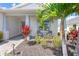 Charming home exterior featuring a manicured front yard, porch, and seating at 16064 Shoreline Dr, Punta Gorda, FL 33982