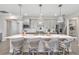 Open-concept kitchen featuring a large island with a quartz countertop and pendant lighting, perfect for entertaining at 16064 Shoreline Dr, Punta Gorda, FL 33982