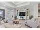 Bright living room showcasing stylish decor, a tray ceiling, and sliding doors at 16064 Shoreline Dr, Punta Gorda, FL 33982