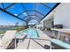 Secluded lanai with private pool, lake view, summer kitchen, and inviting outdoor seating at 16064 Shoreline Dr, Punta Gorda, FL 33982