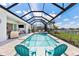 Inviting screened-in pool with spa, outdoor seating, and view of the backyard lake at 16064 Shoreline Dr, Punta Gorda, FL 33982