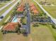 Aerial view of community featuring tile roofs, swimming pool, tropical trees and well-maintained landscaping at 16308 Sunset Palms Blvd # 1702, Punta Gorda, FL 33955