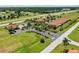 Beautiful aerial view of community residences, landscaping, roads, and amenities including community pool at 16308 Sunset Palms Blvd # 1702, Punta Gorda, FL 33955