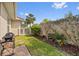 Well-manicured backyard featuring decorative rocks, colorful flower pots, and a gas grill at 16308 Sunset Palms Blvd # 1702, Punta Gorda, FL 33955