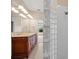 Bathroom featuring double sinks, glass block accent and neutral tile at 16308 Sunset Palms Blvd # 1702, Punta Gorda, FL 33955