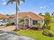 Beautiful home showcasing a lush green lawn, a two-car garage, and well-maintained landscaping with palm trees at 16308 Sunset Palms Blvd # 1702, Punta Gorda, FL 33955