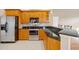 Well-appointed kitchen with stainless steel appliances, dark countertops, and wooden cabinets at 16308 Sunset Palms Blvd # 1702, Punta Gorda, FL 33955