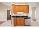 Modern kitchen area featuring wooden cabinets, stainless steel appliances, and dark countertops at 16308 Sunset Palms Blvd # 1702, Punta Gorda, FL 33955
