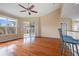 Bright living room with hardwood floors, a ceiling fan, sliding door to outside and a breakfast bar at 16308 Sunset Palms Blvd # 1702, Punta Gorda, FL 33955