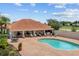 Inviting community pool with ample lounge seating on a brick patio, with verdant landscaping nearby at 16308 Sunset Palms Blvd # 1702, Punta Gorda, FL 33955