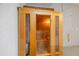 Inviting wooden sauna featuring glass door, built-in benches and wood bucket at 16308 Sunset Palms Blvd # 1702, Punta Gorda, FL 33955
