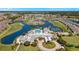 Picturesque aerial view of a community featuring a large pool, tennis courts, and scenic golf course at 1848 Birmingham Blvd, Port Charlotte, FL 33980