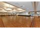 Expansive ballroom with hardwood dance floor, stage, and elegant lighting, perfect for events and gatherings at 1848 Birmingham Blvd, Port Charlotte, FL 33980