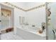 Bright bathroom with garden tub, tiled surround, large window, and separate shower at 1848 Birmingham Blvd, Port Charlotte, FL 33980