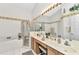 Bright bathroom featuring double sinks, separate shower, and garden tub at 1848 Birmingham Blvd, Port Charlotte, FL 33980