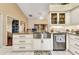 Kitchen showcasing stainless steel appliances, granite countertops, and tiled flooring at 1848 Birmingham Blvd, Port Charlotte, FL 33980