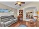 Comfortable living room with beautiful wood floors, sofa seating, and an archway to dining at 1848 Birmingham Blvd, Port Charlotte, FL 33980