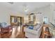 Bright living room with vaulted ceiling, ceiling fan, hardwood floors, and access to sunroom at 1848 Birmingham Blvd, Port Charlotte, FL 33980