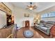 Cozy living room with wood flooring, comfortable seating, and a ceiling fan for added comfort at 1848 Birmingham Blvd, Port Charlotte, FL 33980