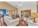 Comfortable living room with wood flooring and access to a sunroom and bedroom at 1848 Birmingham Blvd, Port Charlotte, FL 33980
