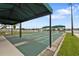 Enjoy outdoor community shuffleboard courts with covered awning and lovely lake views at 1848 Birmingham Blvd, Port Charlotte, FL 33980