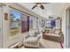 Bright sun room with purple-tinted windows and comfortable seating to enjoy the outdoor views at 1848 Birmingham Blvd, Port Charlotte, FL 33980