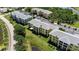 Aerial view of yellow apartment buildings within a lush, green community near the water at 2060 Willow Hammock Cir # 207, Punta Gorda, FL 33983