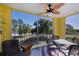 Screened balcony with seating area and scenic views of trees and community at 2060 Willow Hammock Cir # 207, Punta Gorda, FL 33983